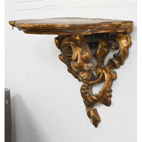 132 - A pair of giltwood and gesso foliate bracket shelves, 20 cm wide x 20 cm high