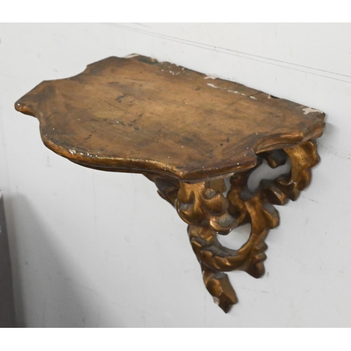 132 - A pair of giltwood and gesso foliate bracket shelves, 20 cm wide x 20 cm high