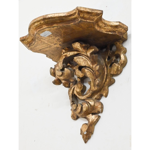 132 - A pair of giltwood and gesso foliate bracket shelves, 20 cm wide x 20 cm high