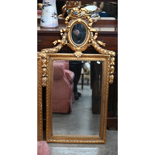 135 - A pair of neo-classical style wall mirrors with small oval and bevelled plates, gilt frames with rib... 