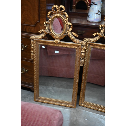 135 - A pair of neo-classical style wall mirrors with small oval and bevelled plates, gilt frames with rib... 