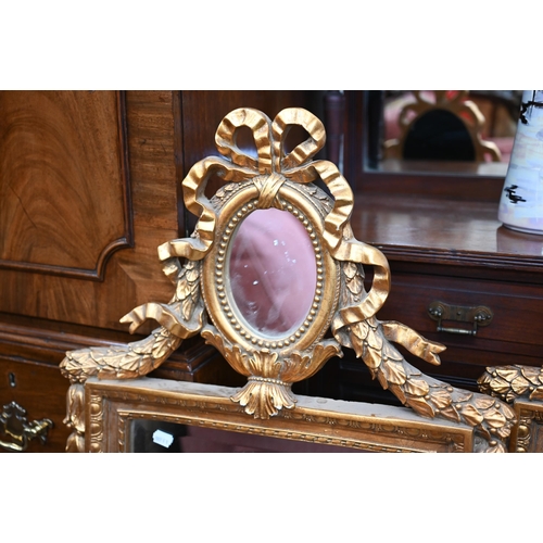 135 - A pair of neo-classical style wall mirrors with small oval and bevelled plates, gilt frames with rib... 