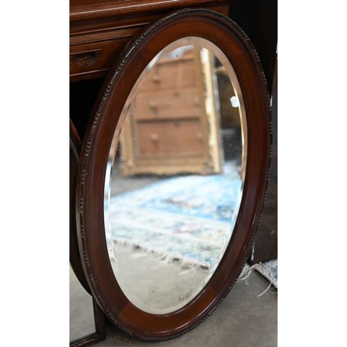 145 - A Gothic arch wall mirror in stained hardwood frame, 62 cm wide x 84 cm high to/w bevelled oval maho... 