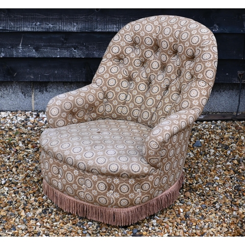 146 - A button back low armchair with floral fabric