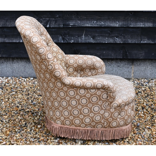 146 - A button back low armchair with floral fabric