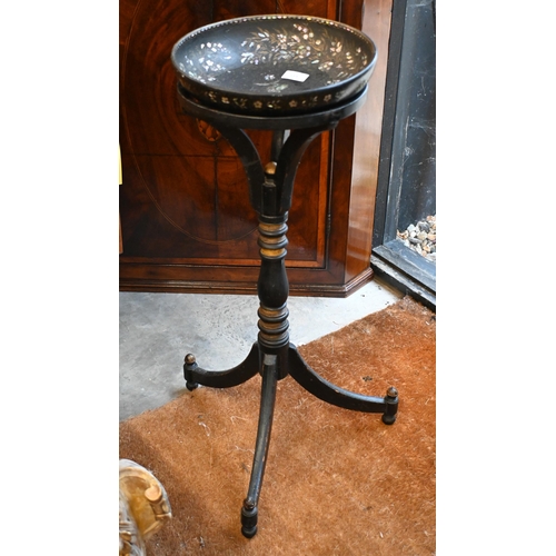 154 - A black papier-maché bowl with mother of pearl inlay on black painted tripod stand, 78 cm high