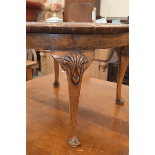 155 - A walnut circular coffee table with scalloped circular quarter veneered top on shell carved cabriole... 