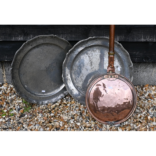 164 - A pair of large scalloped polished pewter chargers, 46 cm diam to/w copper warming pan (2)