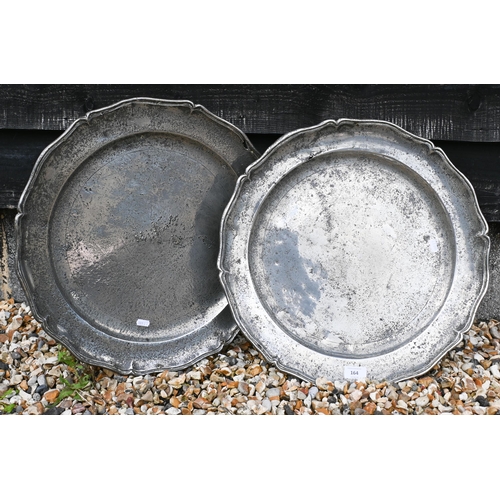 164 - A pair of large scalloped polished pewter chargers, 46 cm diam to/w copper warming pan (2)