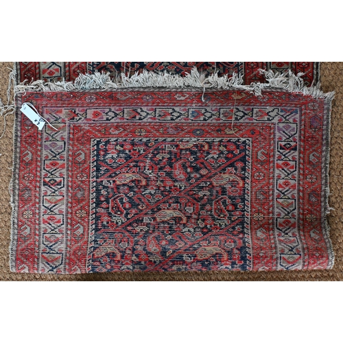 168 - An antique N W Persian runner of boteh design on navy ground, red and beige borders, worn, 406 x 90 ... 