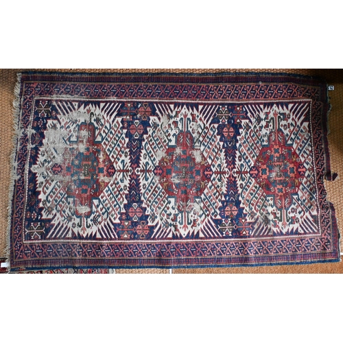 185 - A Caucasian geometric triple medallion rug, blue ground, 196 cm  x 109 cm