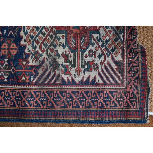 185 - A Caucasian geometric triple medallion rug, blue ground, 196 cm  x 109 cm