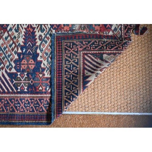 185 - A Caucasian geometric triple medallion rug, blue ground, 196 cm  x 109 cm