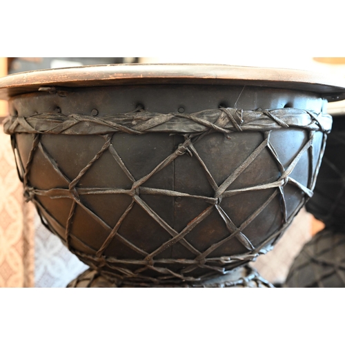 19 - A pair of black painted and lattice leather work Diablo side tables, 48 cm diam x 45 cm high