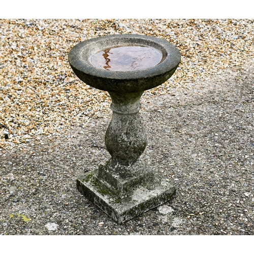 205 - A weathered composite stone birdbath, 35 cm dia. x 53 cm h