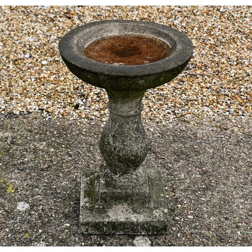 205 - A weathered composite stone birdbath, 35 cm dia. x 53 cm h