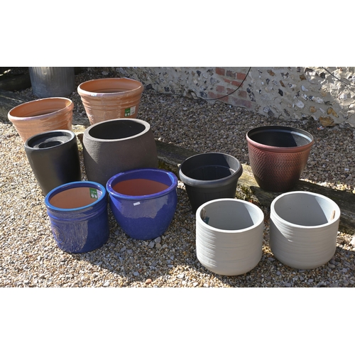 209 - An assortment of new ex-stock composite garden planters to/w blue glazed pottery planters (10)