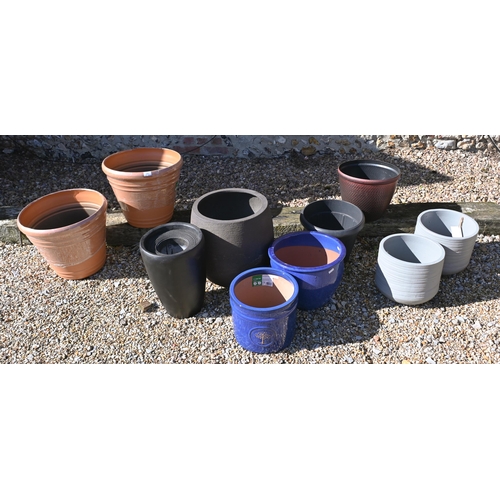 209 - An assortment of new ex-stock composite garden planters to/w blue glazed pottery planters (10)