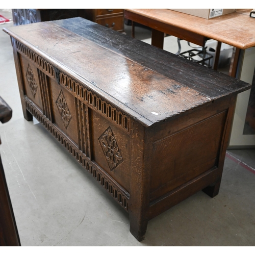 21 - An antique oak coffer, panelled construction with carved front 130 x 50 x 56 cm high