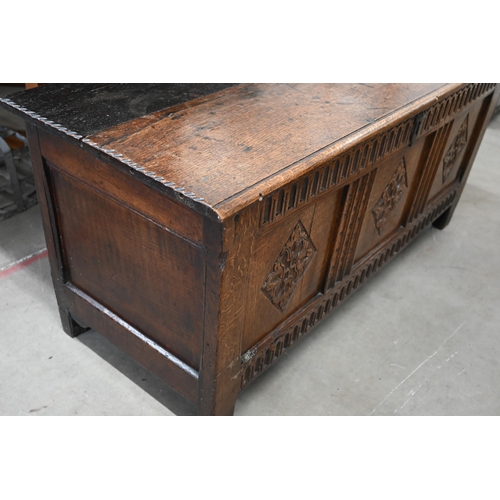 21 - An antique oak coffer, panelled construction with carved front 130 x 50 x 56 cm high