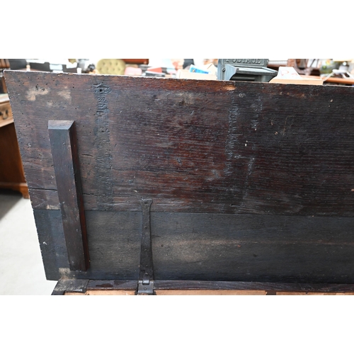 21 - An antique oak coffer, panelled construction with carved front 130 x 50 x 56 cm high