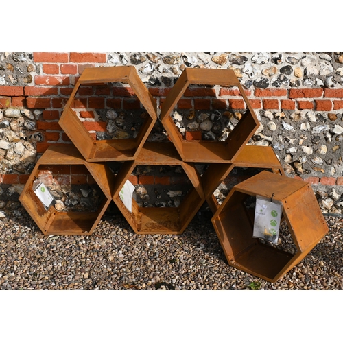 210 - Blumfeldt, six hexagonal steel stacking log store bins, each 50 cm dia. surface rust due to exposure... 