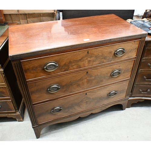 24 - A 19th century mahogany chest of three long graduating drawers (one front foot cut down/reduced), 94... 