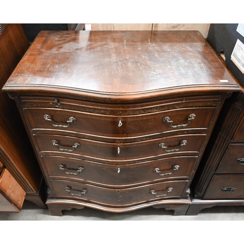 25 - A reproduction mahogany serpentine front chest with brushing slide over four drawers raised on brack... 