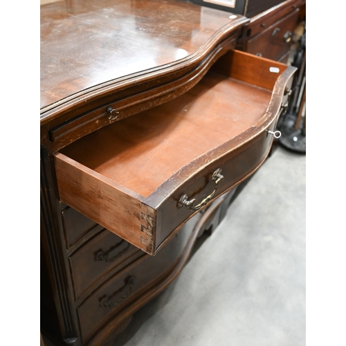 25 - A reproduction mahogany serpentine front chest with brushing slide over four drawers raised on brack... 