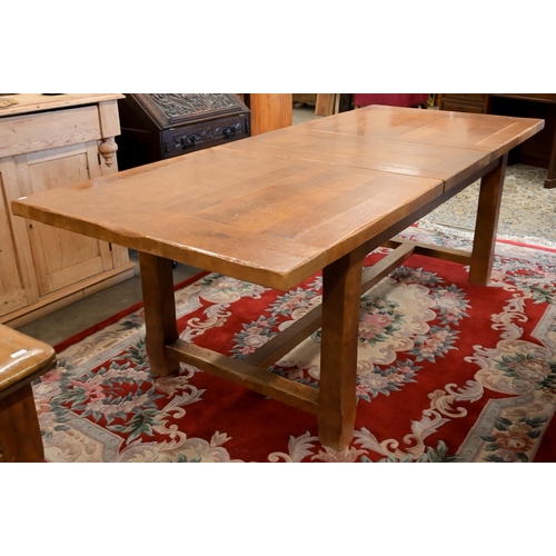 30 - An cherry wood extending dining table with single central leaf, square supports and stretcher, 230 x... 