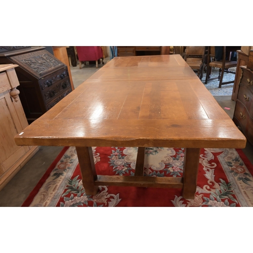 30 - An cherry wood extending dining table with single central leaf, square supports and stretcher, 230 x... 