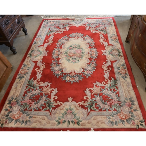 33 - A Chinese cut-wool carpet, floral design on red ground, 277 x 184 cm