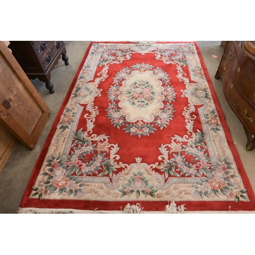 33 - A Chinese cut-wool carpet, floral design on red ground, 277 x 184 cm