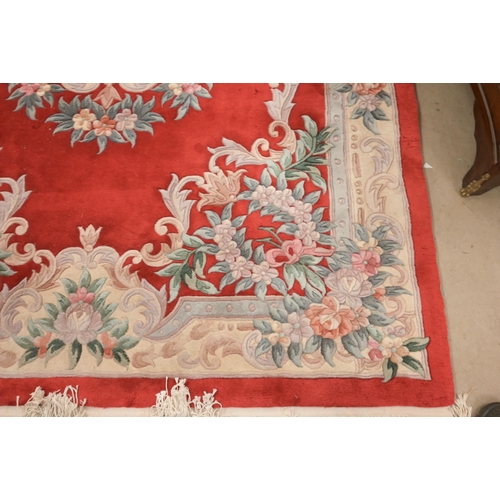 33 - A Chinese cut-wool carpet, floral design on red ground, 277 x 184 cm