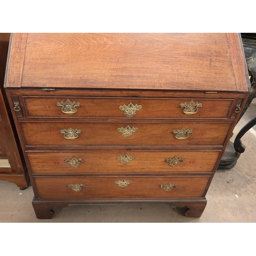 35 - A Georgian mahogany bureau with fall front panel and four long graduating drawers on bracket feet, a... 