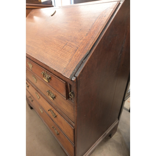 35 - A Georgian mahogany bureau with fall front panel and four long graduating drawers on bracket feet, a... 