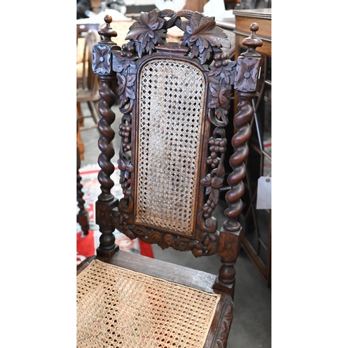 40 - # Five Victorian Gothic revival carved oak dining chairs with woven cane backs and seats (5)