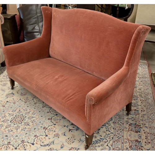 45 - An Edwardian mahogany framed camel back two seater settee, pink dralon upholstery, square supports a... 