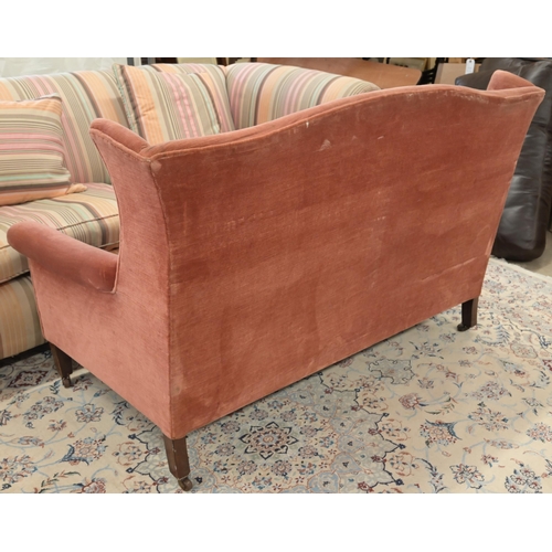 45 - An Edwardian mahogany framed camel back two seater settee, pink dralon upholstery, square supports a... 