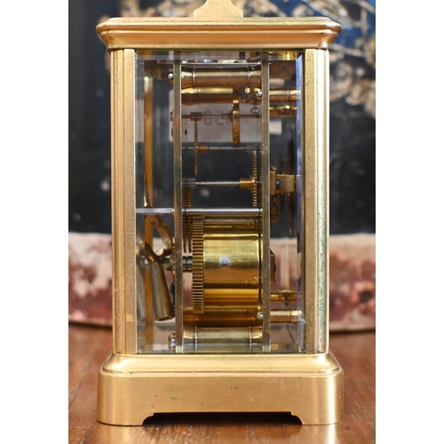 458 - A gilt brass carriage timepiece with top swing handle and bevelled glass panels, 18 cm high overall