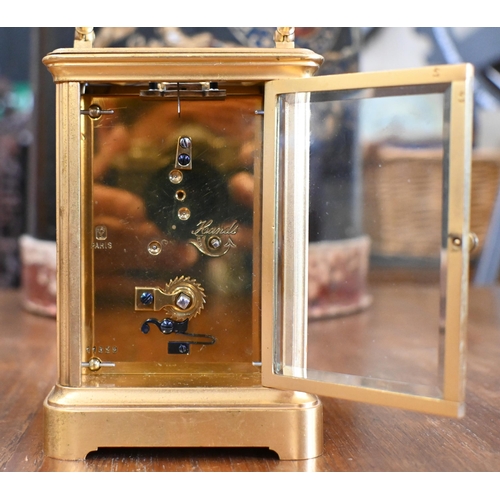 458 - A gilt brass carriage timepiece with top swing handle and bevelled glass panels, 18 cm high overall