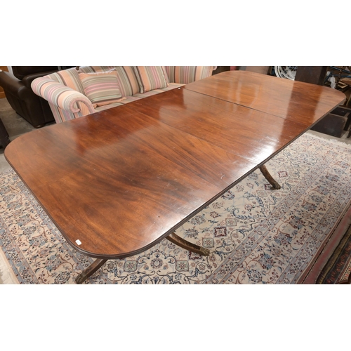 46 - A Regency style mahogany extending dining table with single central leaf on twin pedestal bases with... 