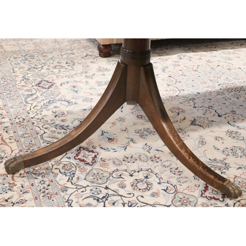 46 - A Regency style mahogany extending dining table with single central leaf on twin pedestal bases with... 