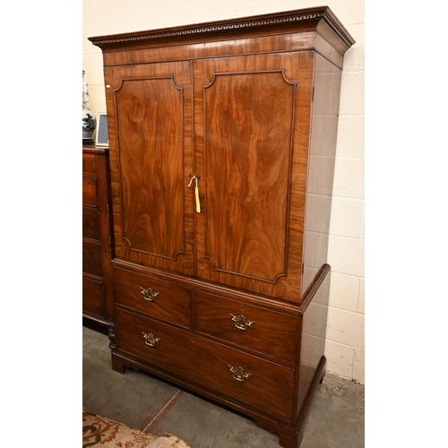 5 - A 19th century mahogany linen press with panelled doors enclosing hanging rail (original slides remo... 