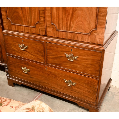 5 - A 19th century mahogany linen press with panelled doors enclosing hanging rail (original slides remo... 