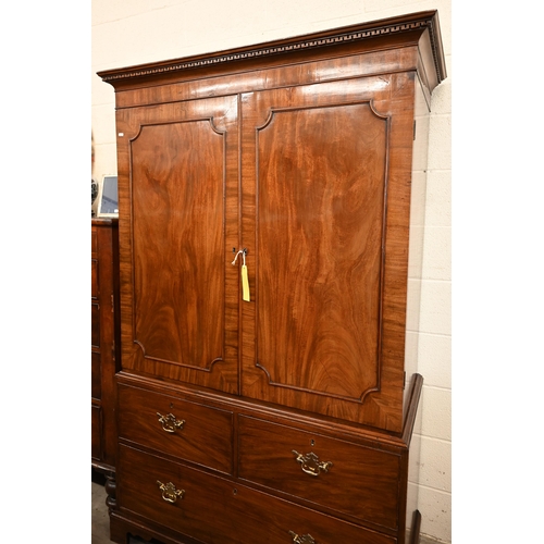 5 - A 19th century mahogany linen press with panelled doors enclosing hanging rail (original slides remo... 