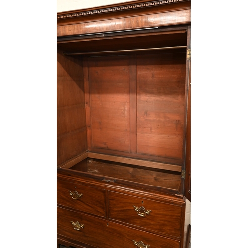 5 - A 19th century mahogany linen press with panelled doors enclosing hanging rail (original slides remo... 