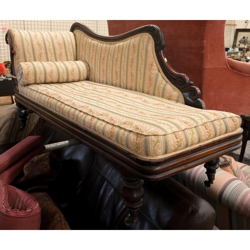 50 - A 19th century rosewood scroll-end chaise with shaped back, Regency floral striped fabric, on turned... 