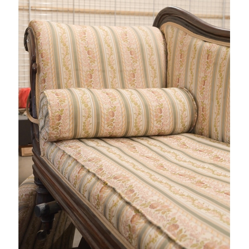 50 - A 19th century rosewood scroll-end chaise with shaped back, Regency floral striped fabric, on turned... 