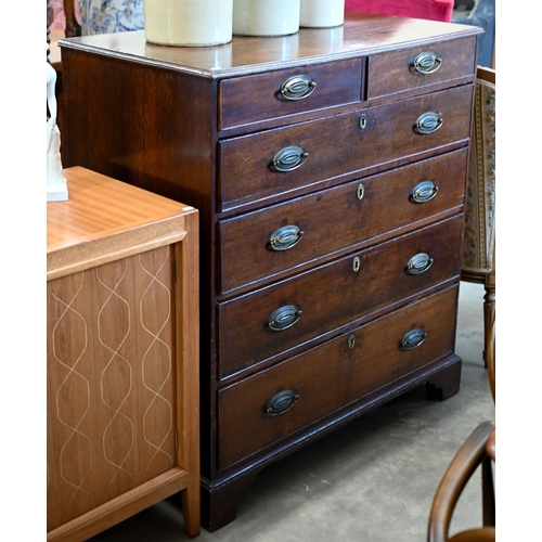 52 - A 19th century oak chest of two short over four long graduating drawers raised on shaped bracket fee... 